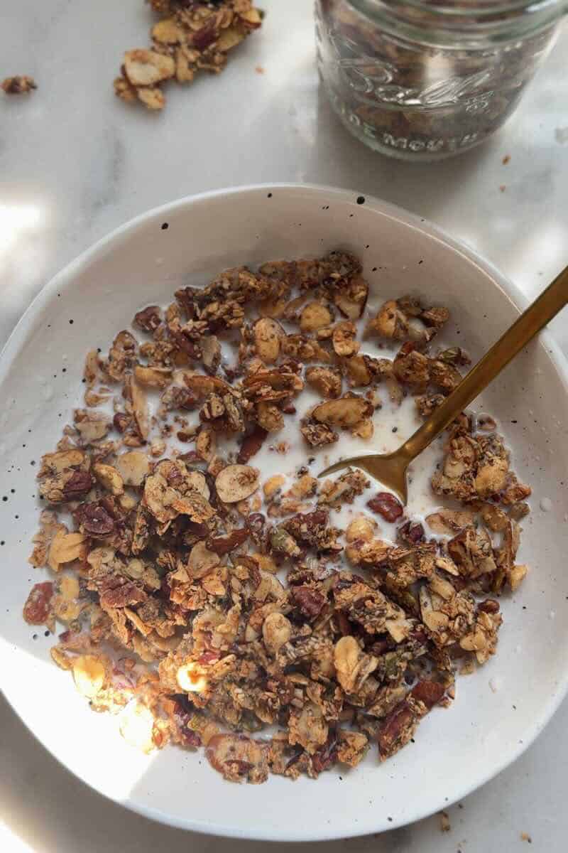 low fodmap granola in a cereal bowl with milk