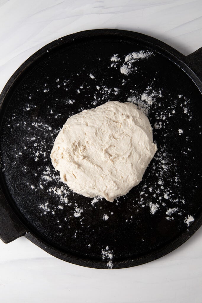 Put gluten free sourdough pizza dough on a cast iron .