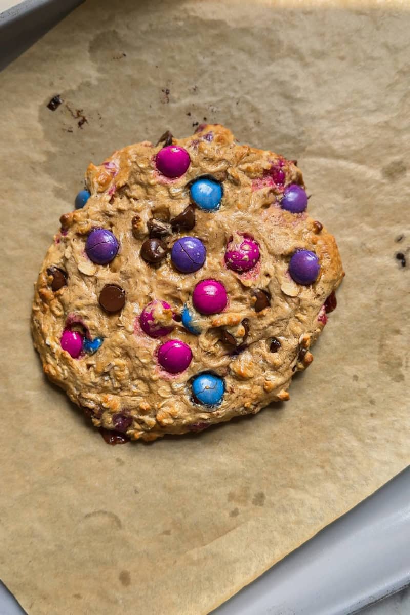 protein monster cookie on a parchment lined baking tray