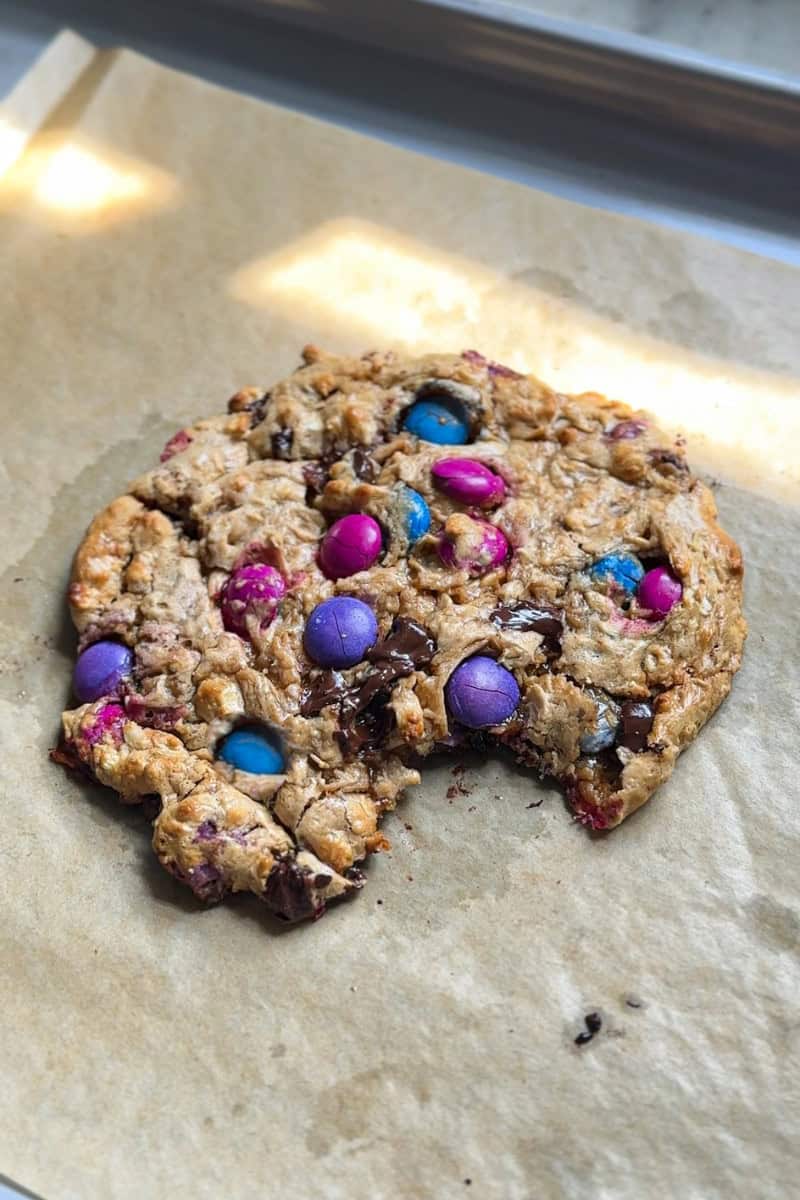 protein cookie on a tray with a bite taken out