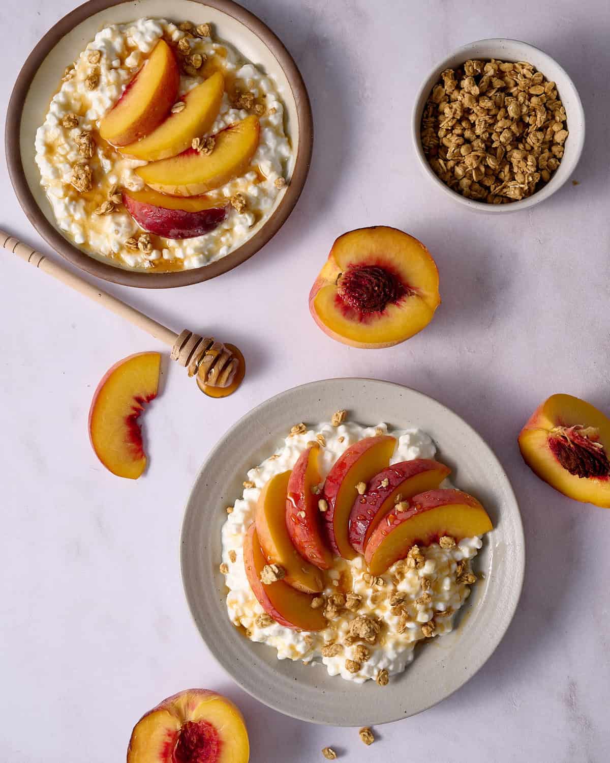 cottage cheese and peaches in bowls with granola