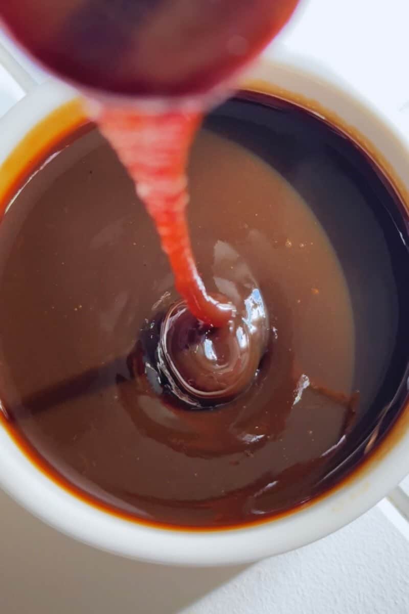 caramelized banana simple syrup pouring into a bowl