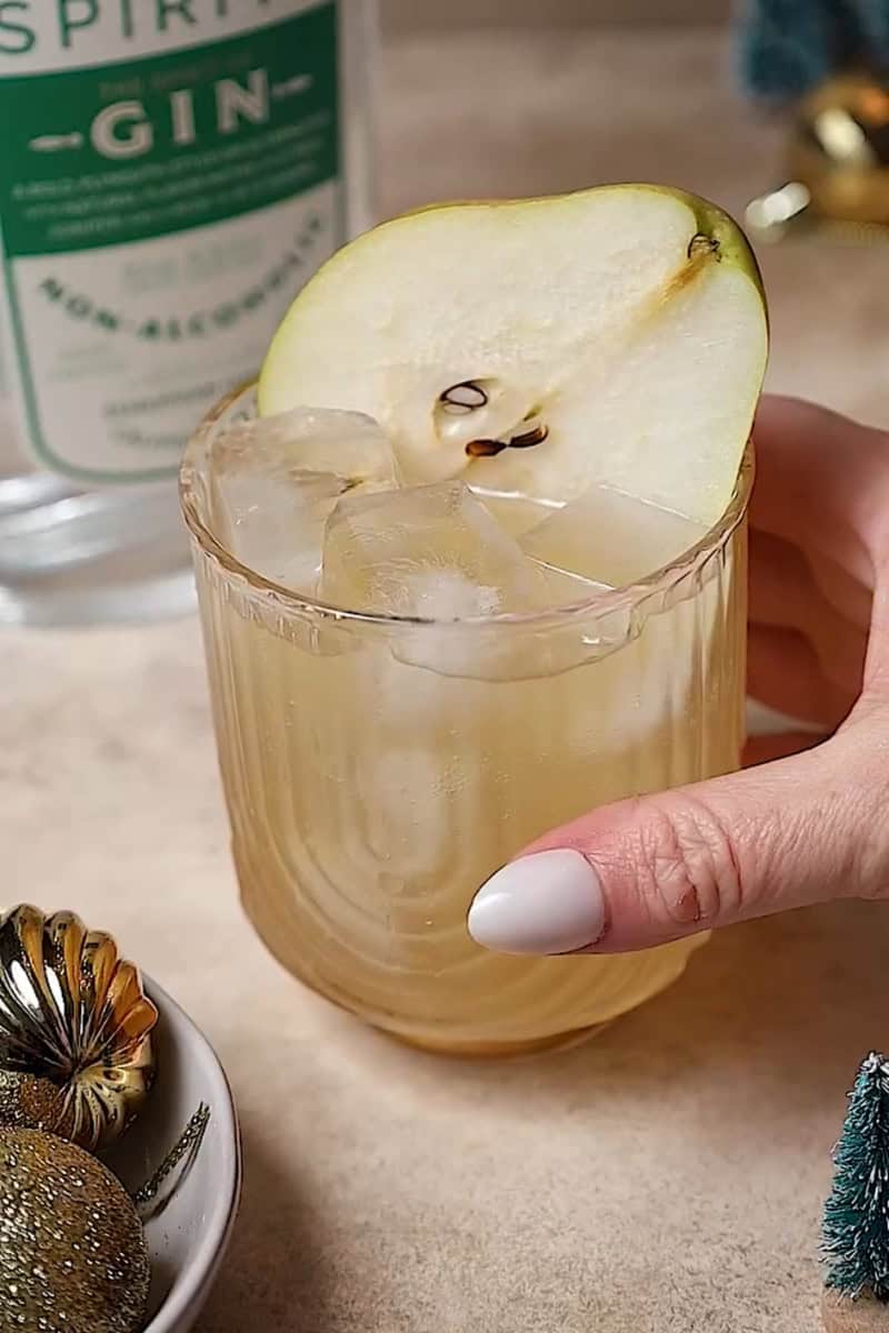 pear mocktail in a glass with a pear slice for garnish