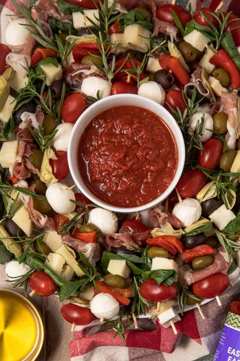 holiday antipasto wreath with bowl of sauce in the center for dipping