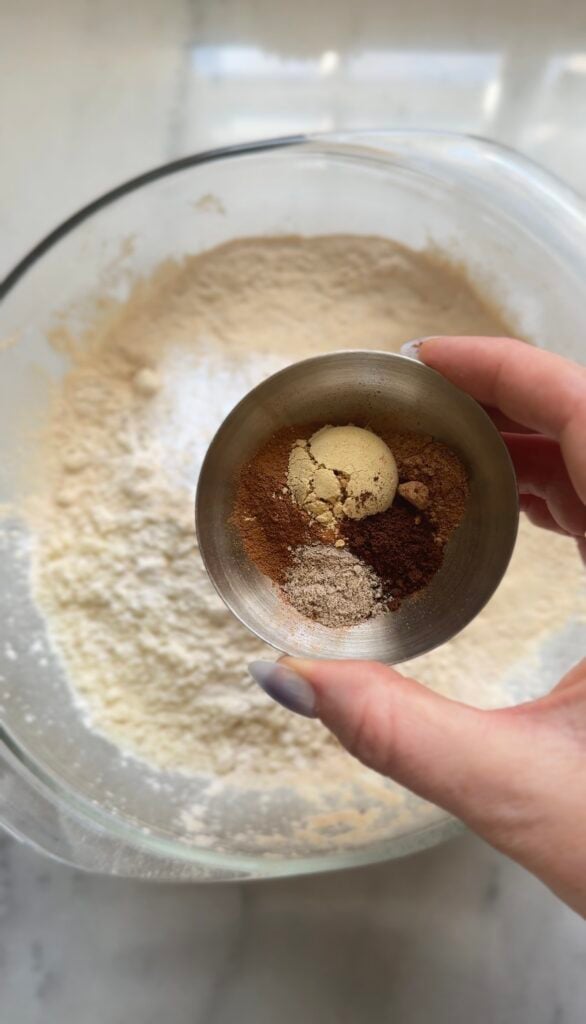 Add and mix spices into the dry ingredients of the high protein carrot cake into a bowl.