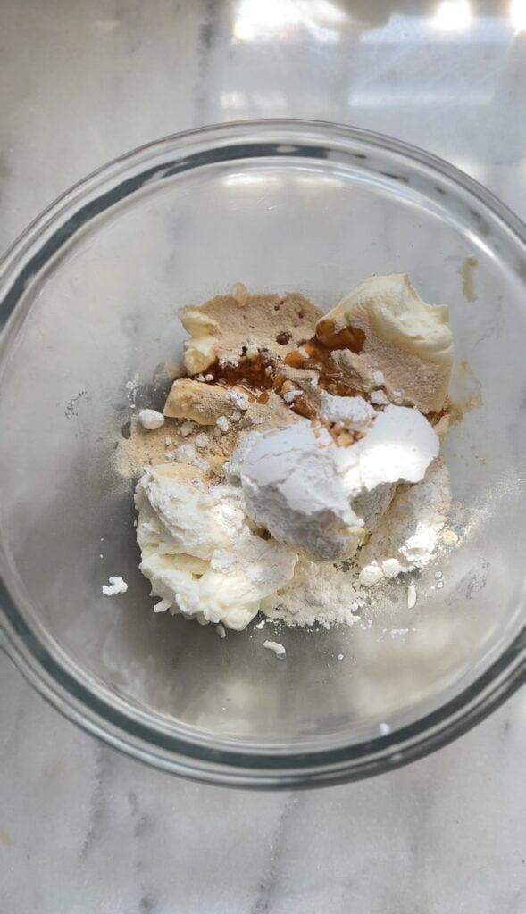 Measure the ingredients of the cream cheese frosting of the high protein carrot cake into a new bowl.