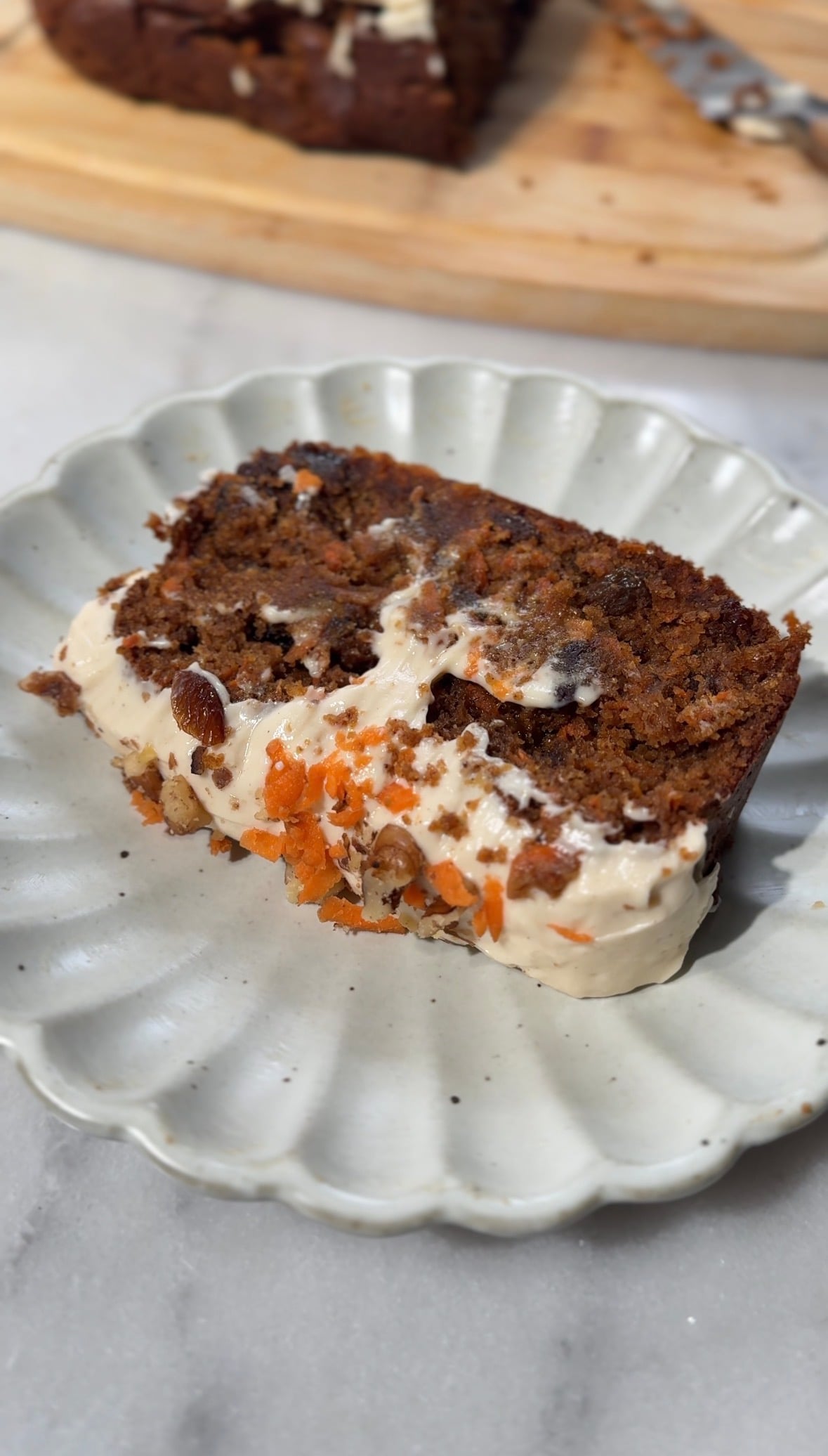 Close up of the baked and frosted Easy High Protein Carrot Cake slice on a plate for serving.
