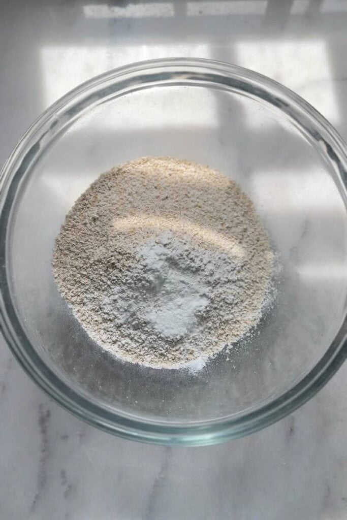 Mixing the dry ingredients for the gluten free blueberry oatmeal protein pancakes in a bowl.