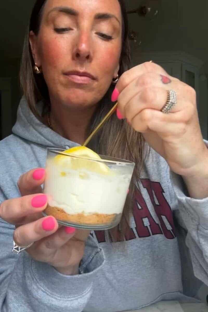 No Bake Lemon Cottage Cheese Cheesecake Cup being enjoyed with a spoon.