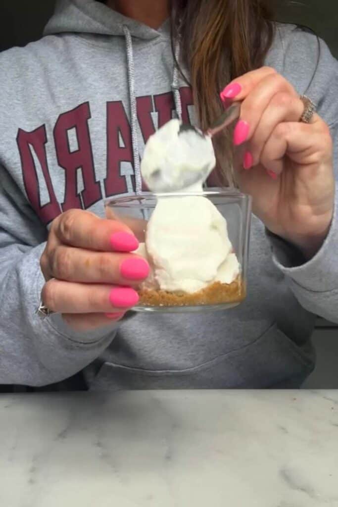 Pour the cheesecake filling of the No Bake Lemon Cottage Cheese Cheesecake Cups on top of the graham cracker crust in the cup.