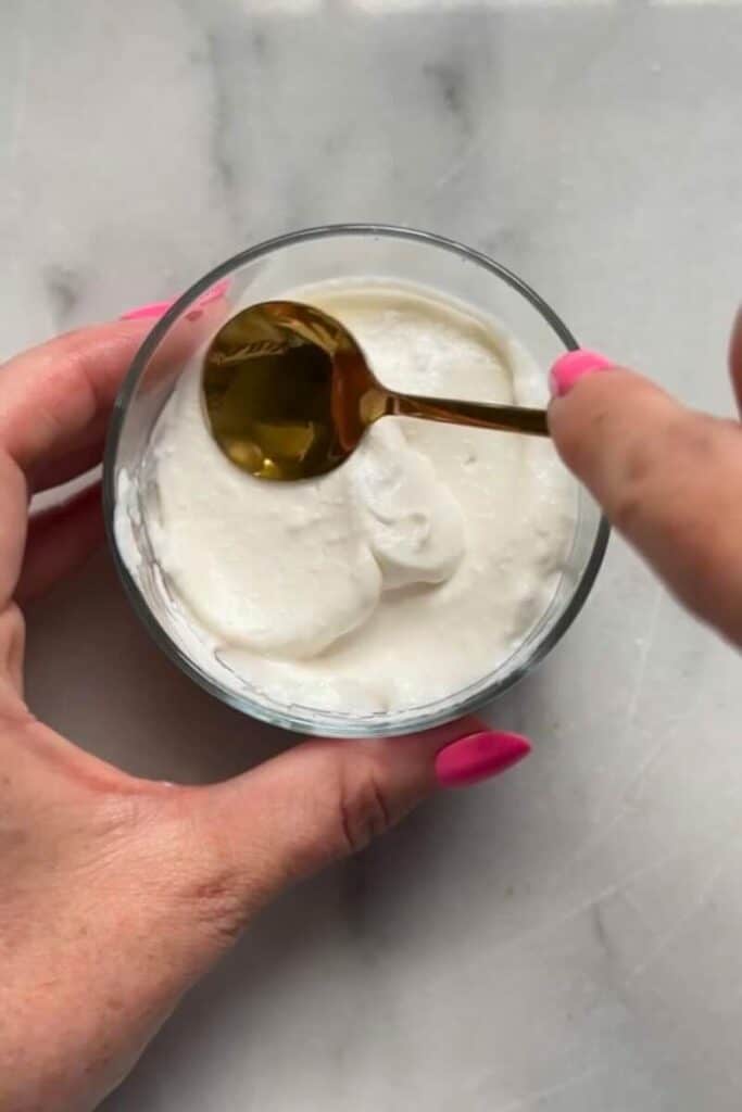 Enjoy the fresh No Bake Lemon Cottage Cheese Cheesecake Cup with a spoon.