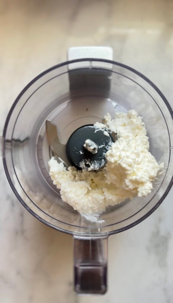 Blending high fat cottage cheese in a food processor for the blueberry protein muffins.