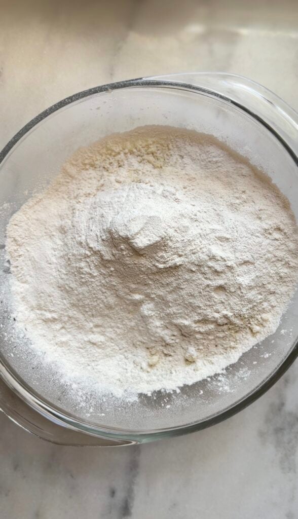 Add the dry ingredients (minus the cinnamon) of the blueberry cottage cheese protein muffins into a bowl.