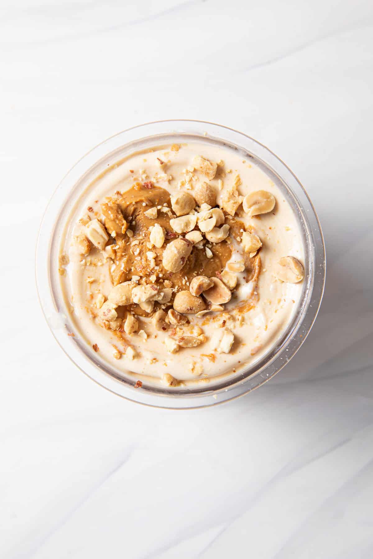 Finished frozen peanut protein ice cream base in the Ninja Creami pint jar after the respin function with the add-ins and toppings.