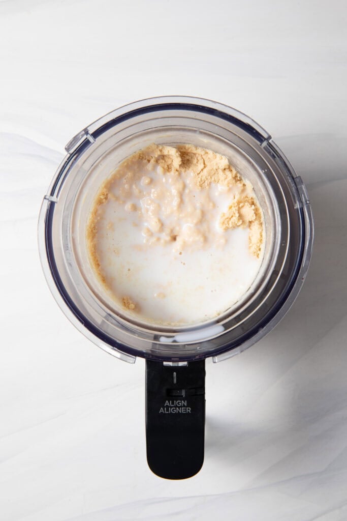 Add more almond milk and mix the frozen peanut protein ice cream base in the Ninja Creami pint jar for the respin function.