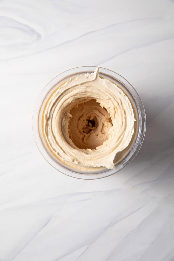 Finished frozen peanut protein ice cream base in the Ninja Creami pint jar after the respin function before add-ins.