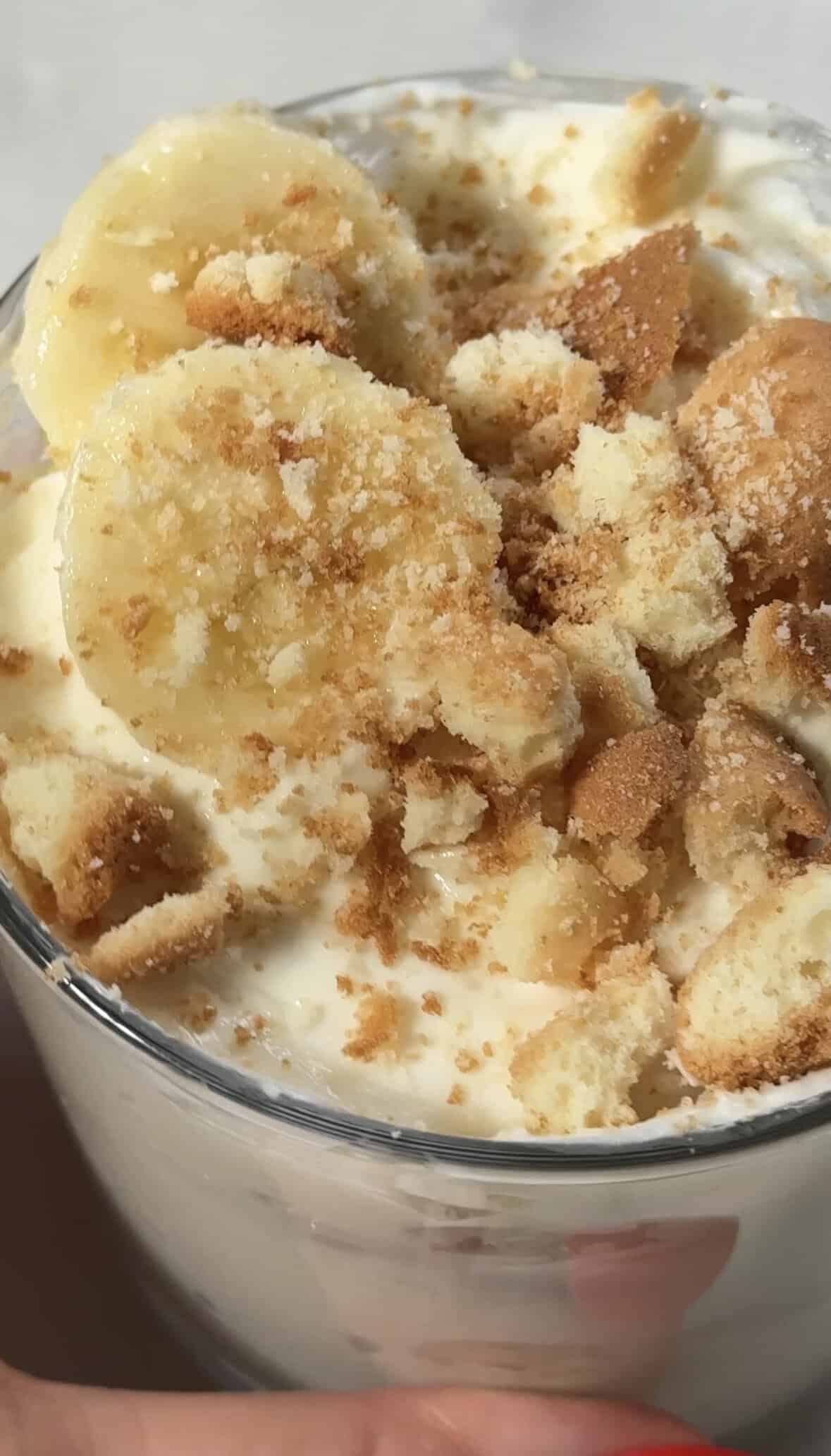 Close up of the finished easy protein banana pudding topped with gluten free vanilla wafers and thinly sliced fresh banana.