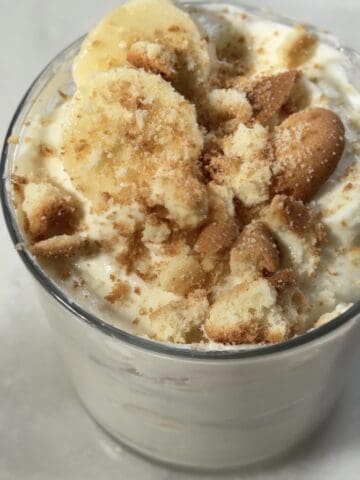 Finished protein banana pudding topped with banana slices and crushed up gluten free vanilla wafers.