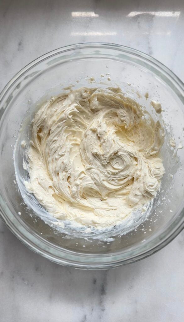 Finished protein cream cheese frosting ingredients in a bowl for the protein lemon cake.