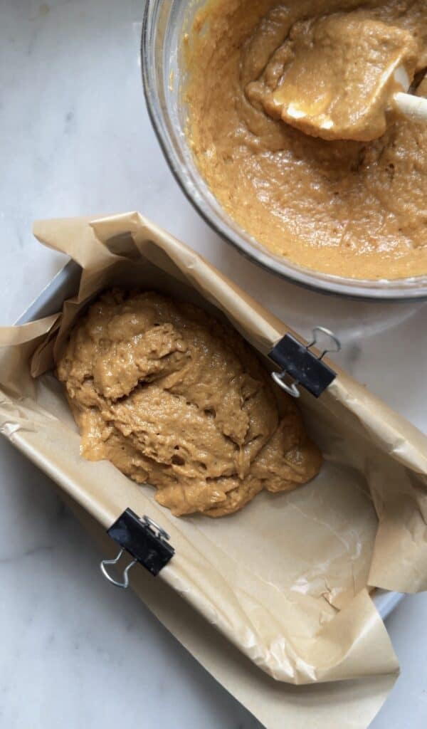 Pour the protein lemon cake batter into the prepared cake loaf pan lined with parchment paper.
