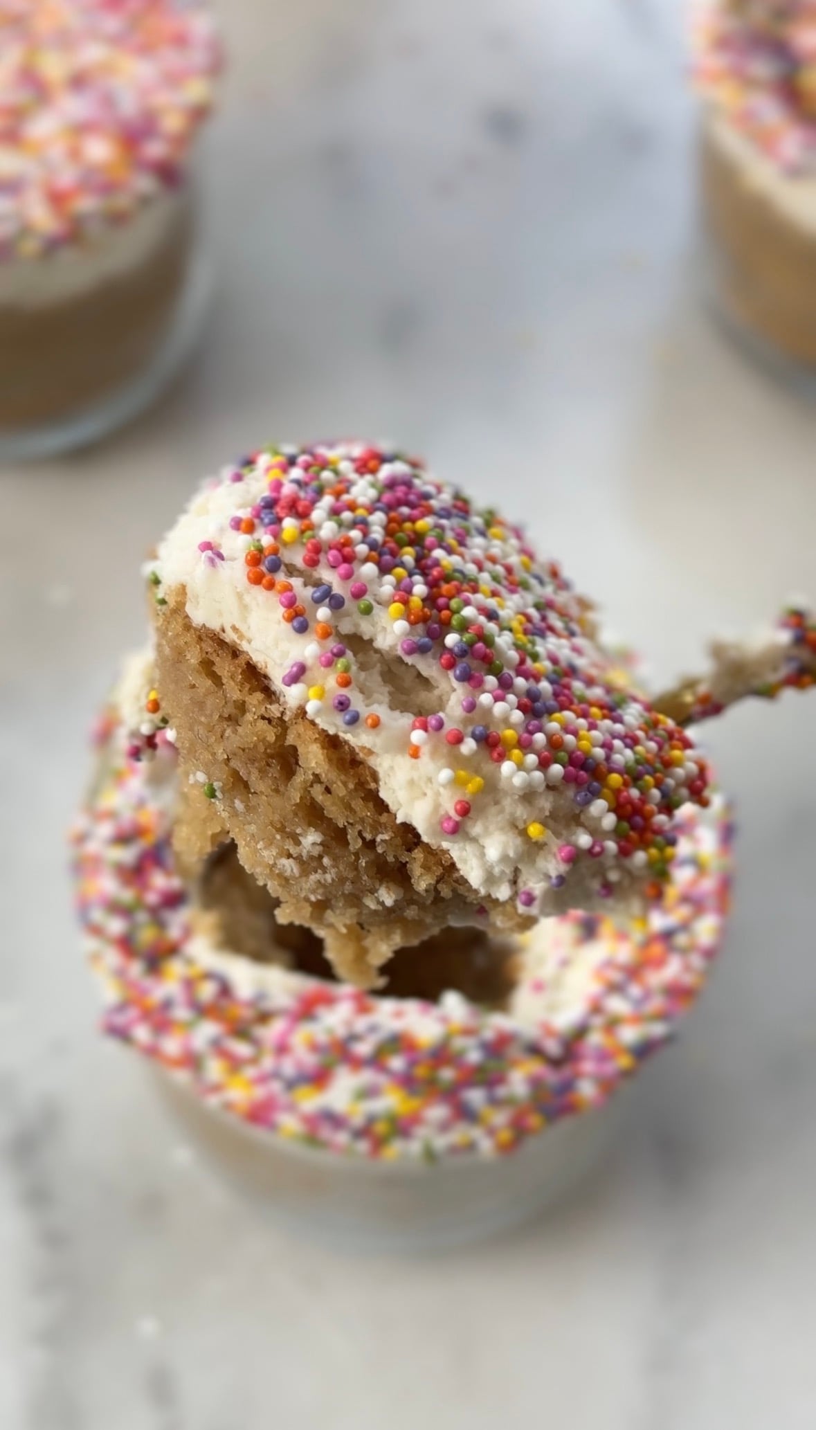 Close up of a spoonful of my dairy free and gluten free version of the viral dot cake recipe in a glass.
