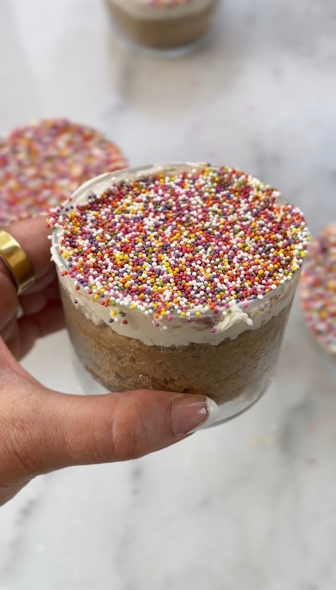 Close up of my dairy free and gluten free version of the viral dot cake recipe in a glass.