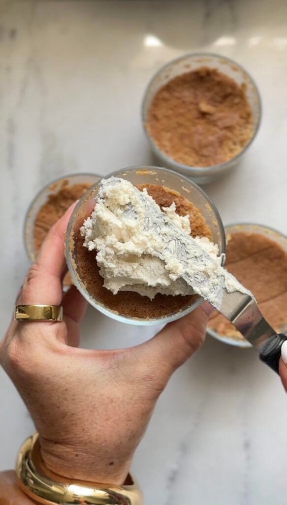 Add the frosting to the dot cake with an icing spatula.
