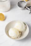 Ninja Creami Lemon Ice Cream Sorbet scooped into a bowl to be eaten with a spoon.