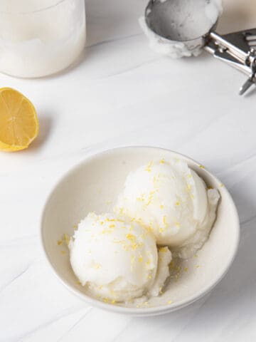 Ninja Creami Lemon Ice Cream Sorbet scooped into a bowl to be eaten with a spoon.