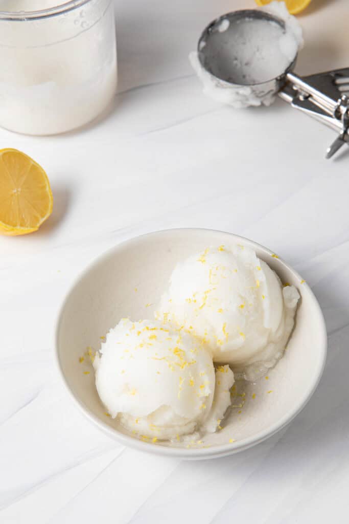 Ninja Creami Lemon Ice Cream Sorbet scooped into a bowl to be eaten with a spoon.
