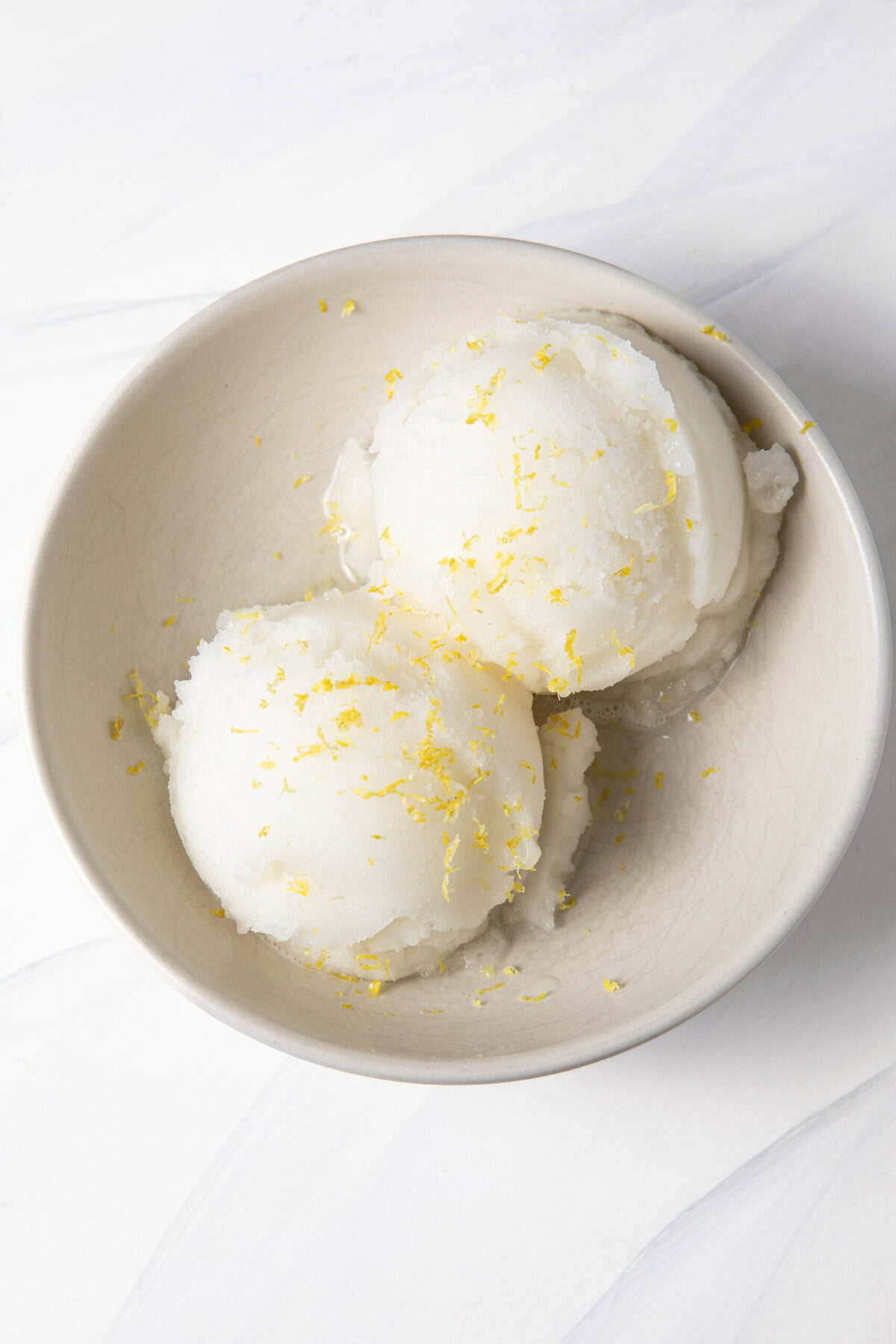 Ninja Creami Lemon Sorbet in a bowl topped with lemon zest.