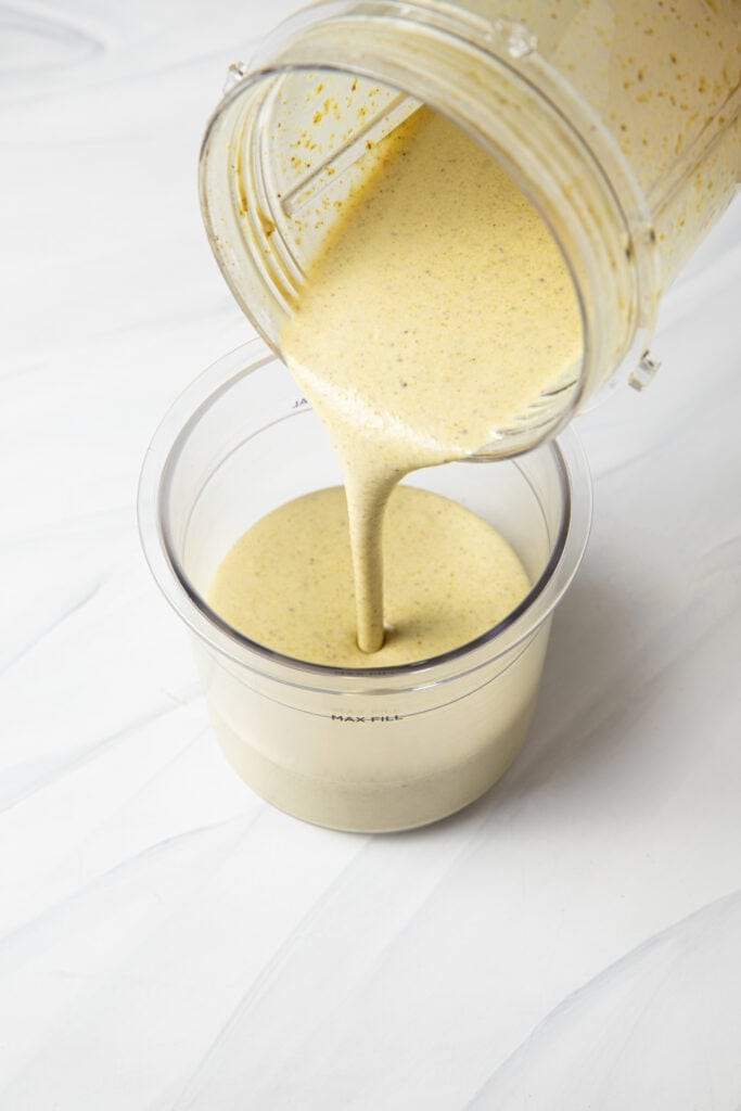 Pour blended ingredients of the pistachio ice cream from the blender bottle into the ninja creami pint.