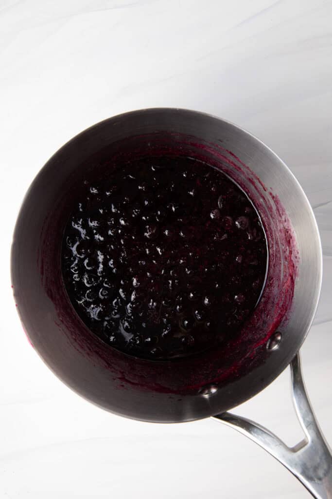 Simmer the Fresh Blueberry Simple Syrup in a saucepan.