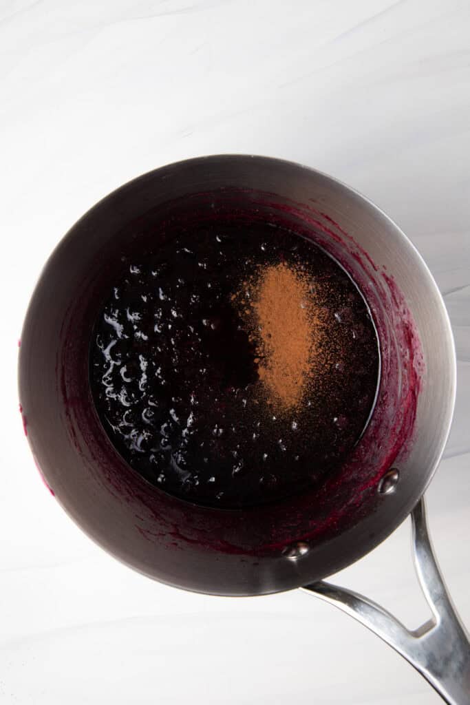 Add vanilla and cinnamon to the saucepan for the Fresh Blueberry Simple Syrup.