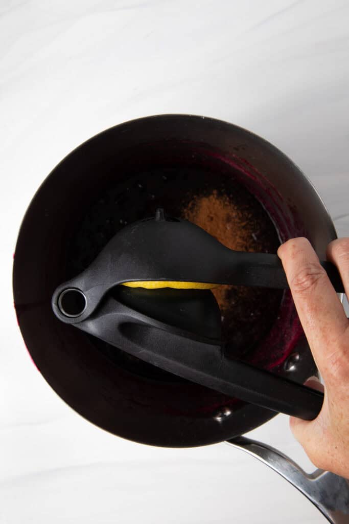 Add the lemon juice to the Fresh Blueberry Simple Syrup in the saucepan.