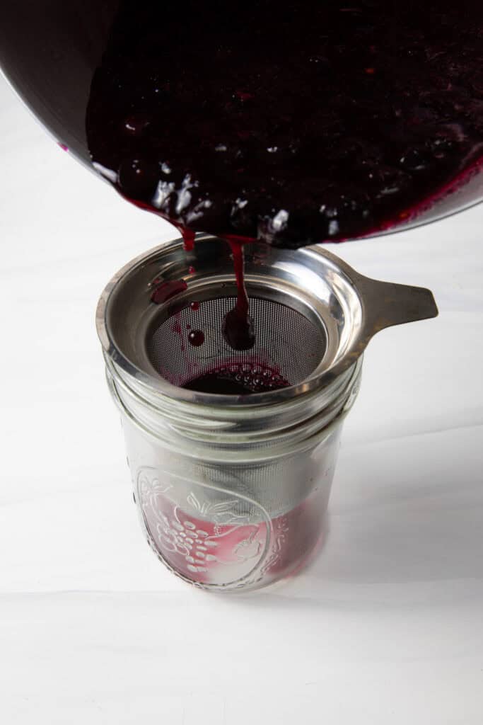 Strain the Fresh Blueberry Simple Syrup through the fine mesh strainer.