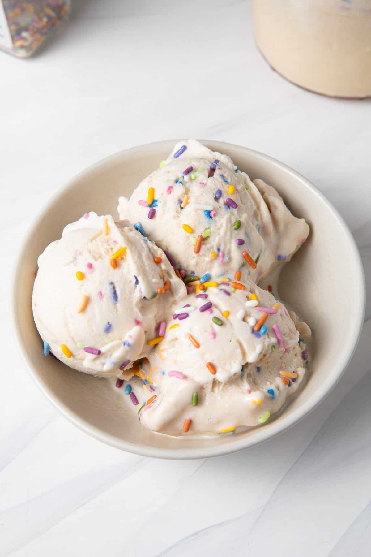 Birthday Cake Batter Protein Ninja Creami Ice Cream scooped in a bowl.