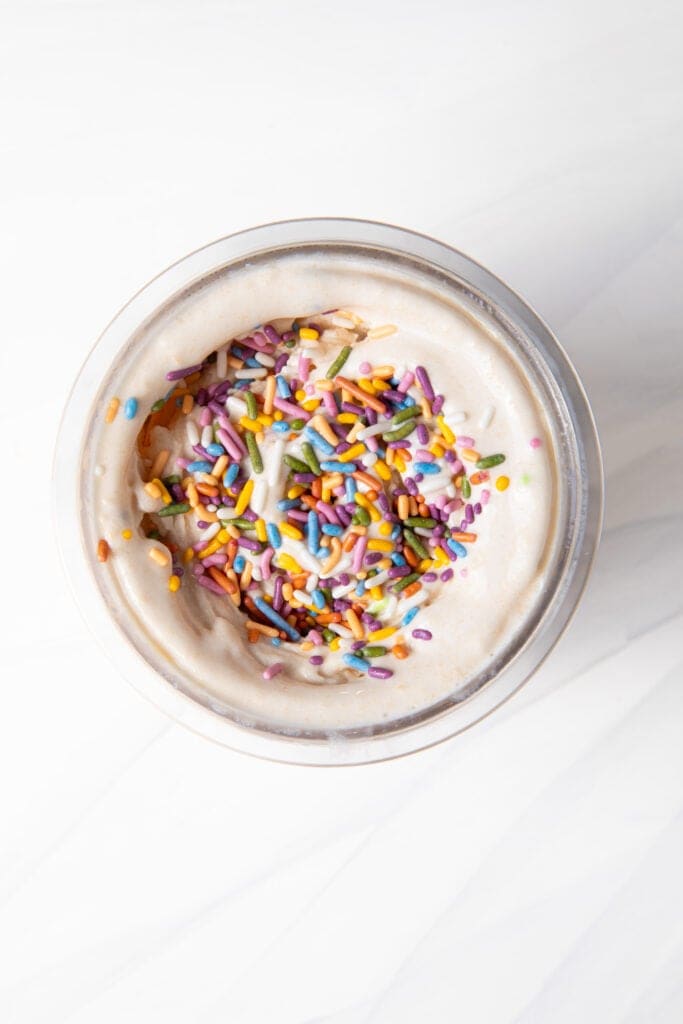 Birthday Cake Batter Protein Ninja Creami Ice Cream base in the Ninja Creami pint before mixing in the mix-ins.