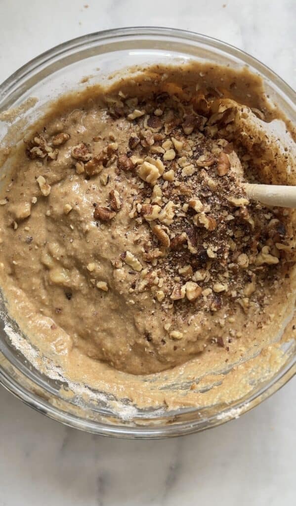 Fold in the walnuts into the batter of the Gluten Free Protein Banana Nut Bread.