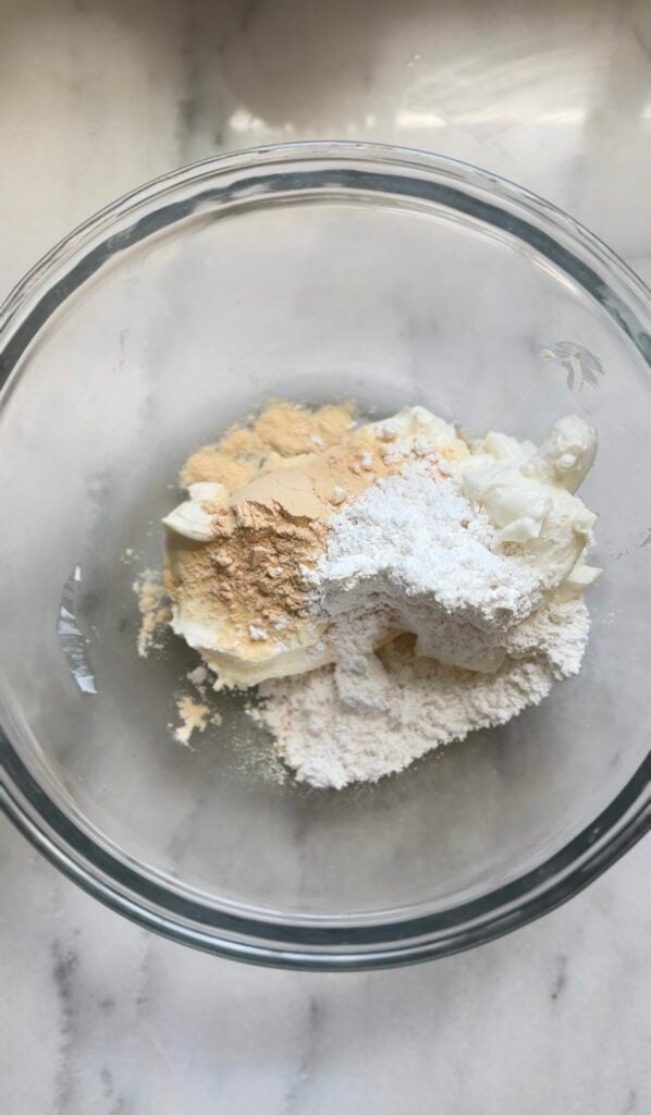 Adding the dry ingredients of the frosting of the Gluten Free Protein Banana Nut Bread into a bowl.