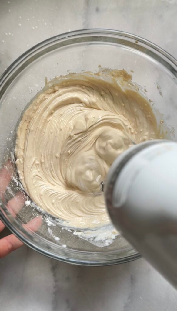 Mixing the frosting of the Gluten Free Protein Banana Nut Bread.