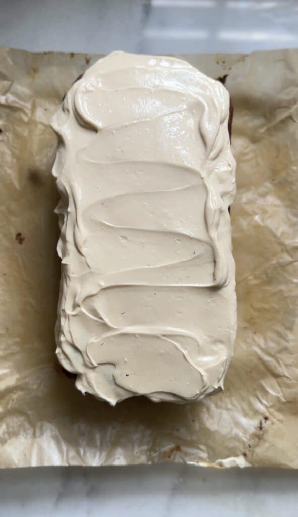 Frosted the Gluten Free Protein Banana Nut Bread with the cream cheese frosting before topping it with caramel banana syrup.