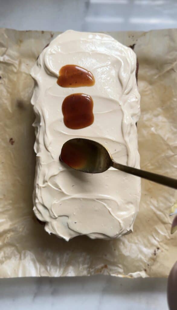Frosted the Gluten Free Protein Banana Nut Bread with the cream cheese frosting while topping it with caramel banana syrup.