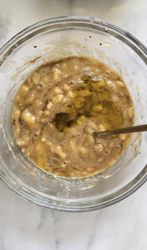 Mixed wet ingredients for the Gluten Free Protein Banana Nut Bread batter.