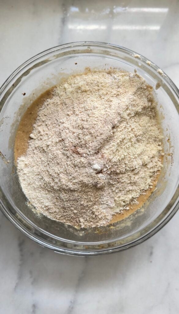 Add the dry ingredients to the wet ingredients for the Gluten Free Protein Banana Nut Bread batter.