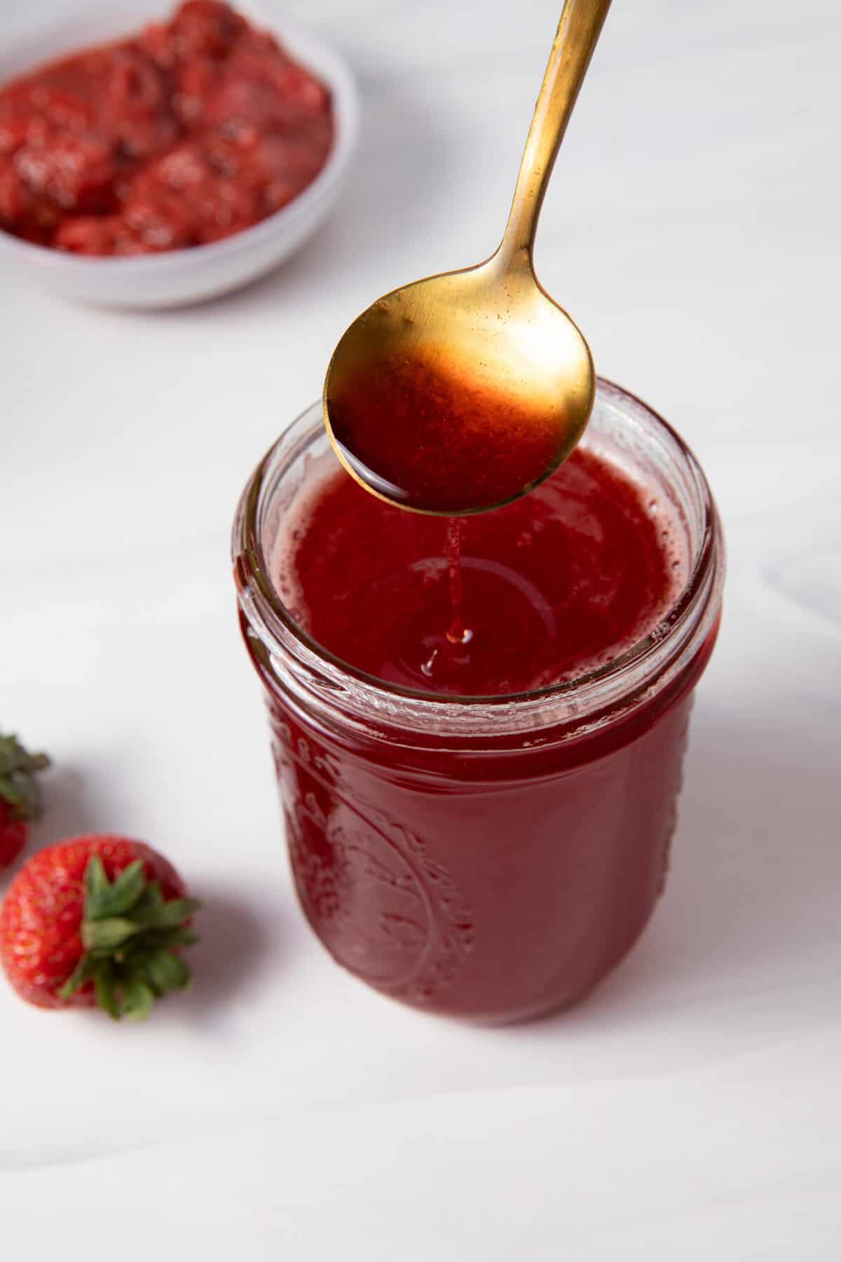 Spoon the Fresh Strawberry Simple Syrup from the mason jar.