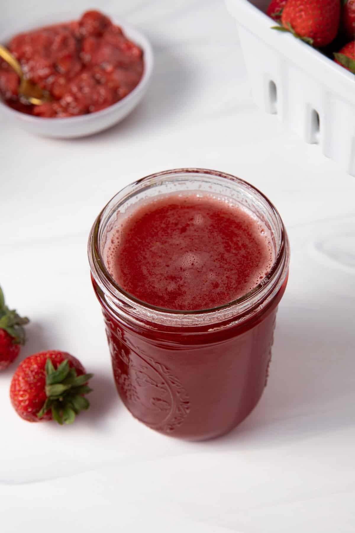Fresh Strawberry Simple Syrup in a mason jar.