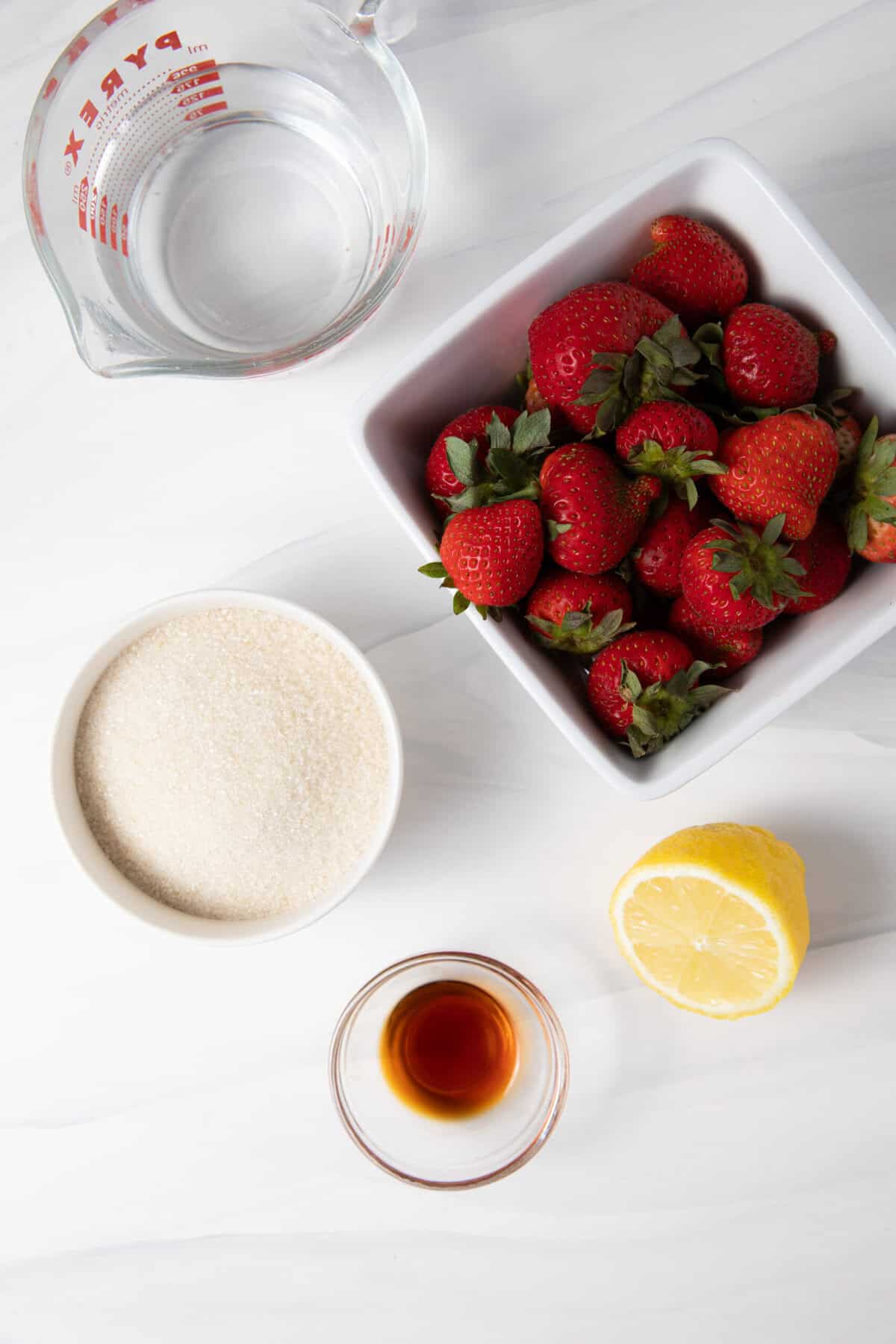 Fresh Strawberry Simple Syrup ingredients on the counter.
