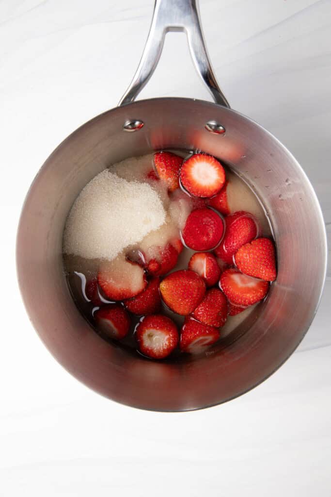 Strawberries, sugar, and water in a saucepan to make the Fresh Strawberry Simple Syrup.