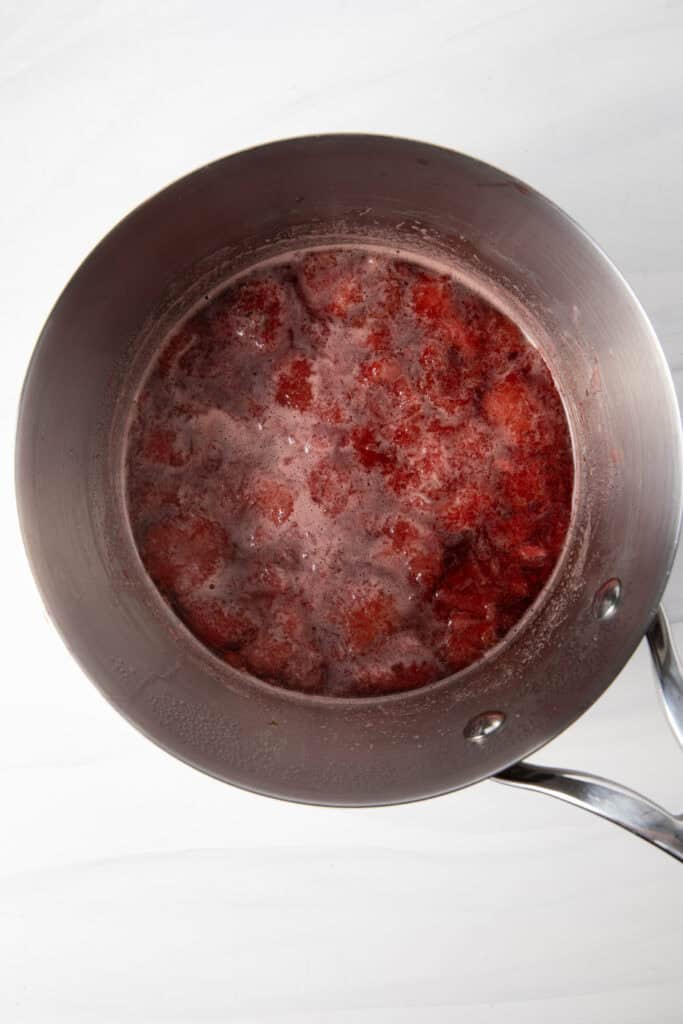Simmer the Fresh Strawberry Simple Syrup in a saucepan.